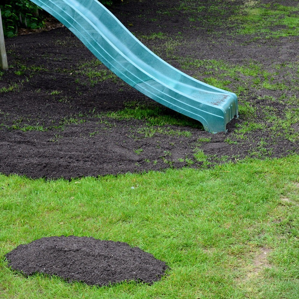 lawn with top dressing about to be applied in garden used by children